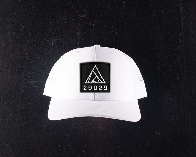 white trucker hat with black patch with a white 29029 lockup logo on the patch.